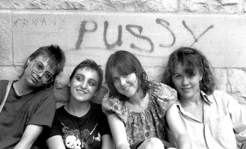 1980s chicago punk band barbie army posing ironically beneath a tag someone had written on their apartment building